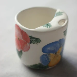 To-go cup with pansies by Dirt Person Ceramics